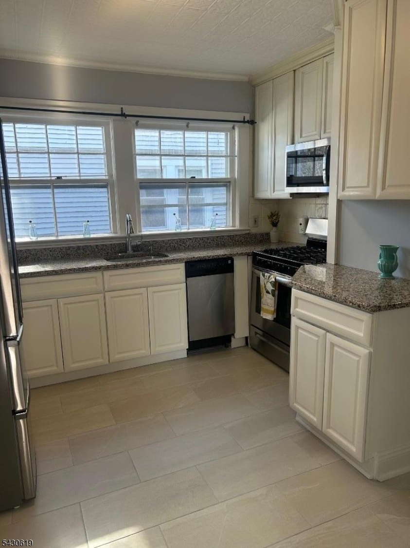 96 Grove Street Montclair, NJ 07042 - Photo 14 of 23 a kitchen with stainless steel appliances granite countertop a stove a sink and a microwave