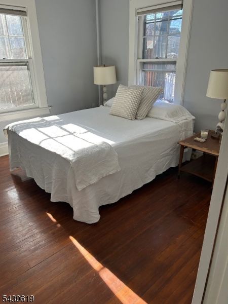 96 Grove Street Montclair, NJ 07042 - Photo 15 of 23 a bedroom with a bed and wooden floor
