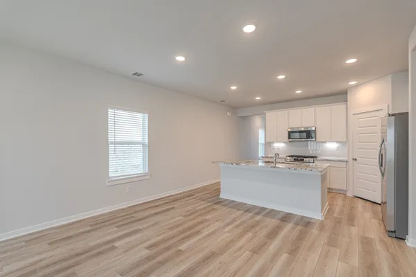 a kitchen with stainless steel appliances granite countertop a stove and a refrigerator