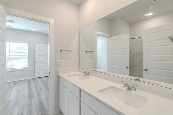 a bathroom with a sink double vanity and a mirror