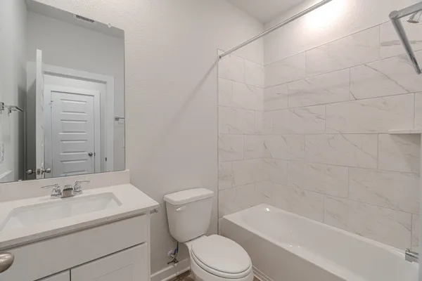 a bathroom with a toilet a sink and bathtub