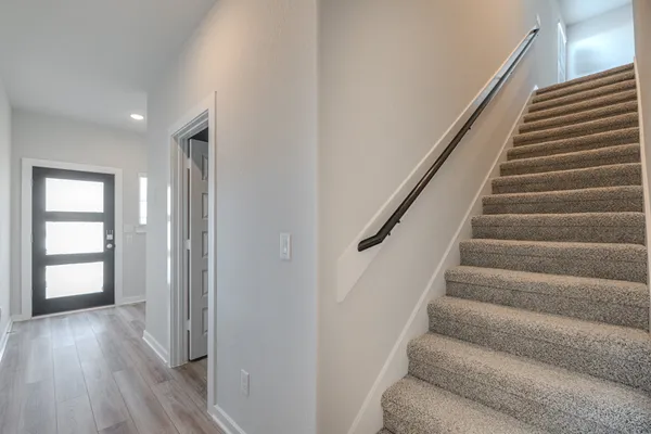 a view of entryway with wooden floor and stairs