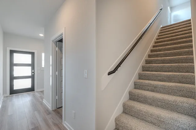 a view of entryway with wooden floor and stairs