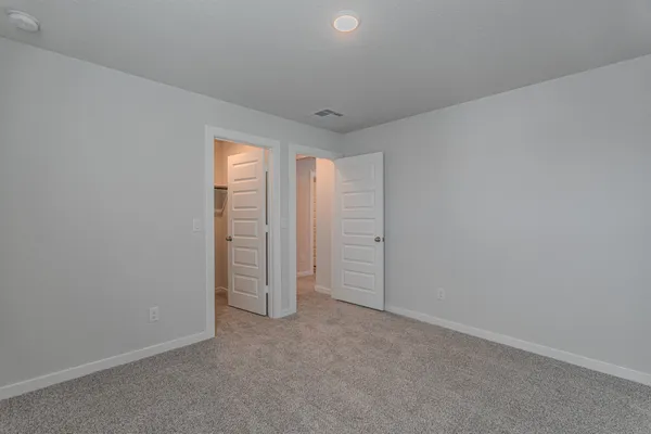 a view of an empty room and a window
