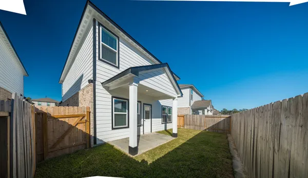 a view of house with backyard