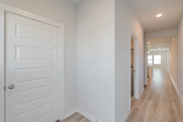 a view of a hallway with wooden floor