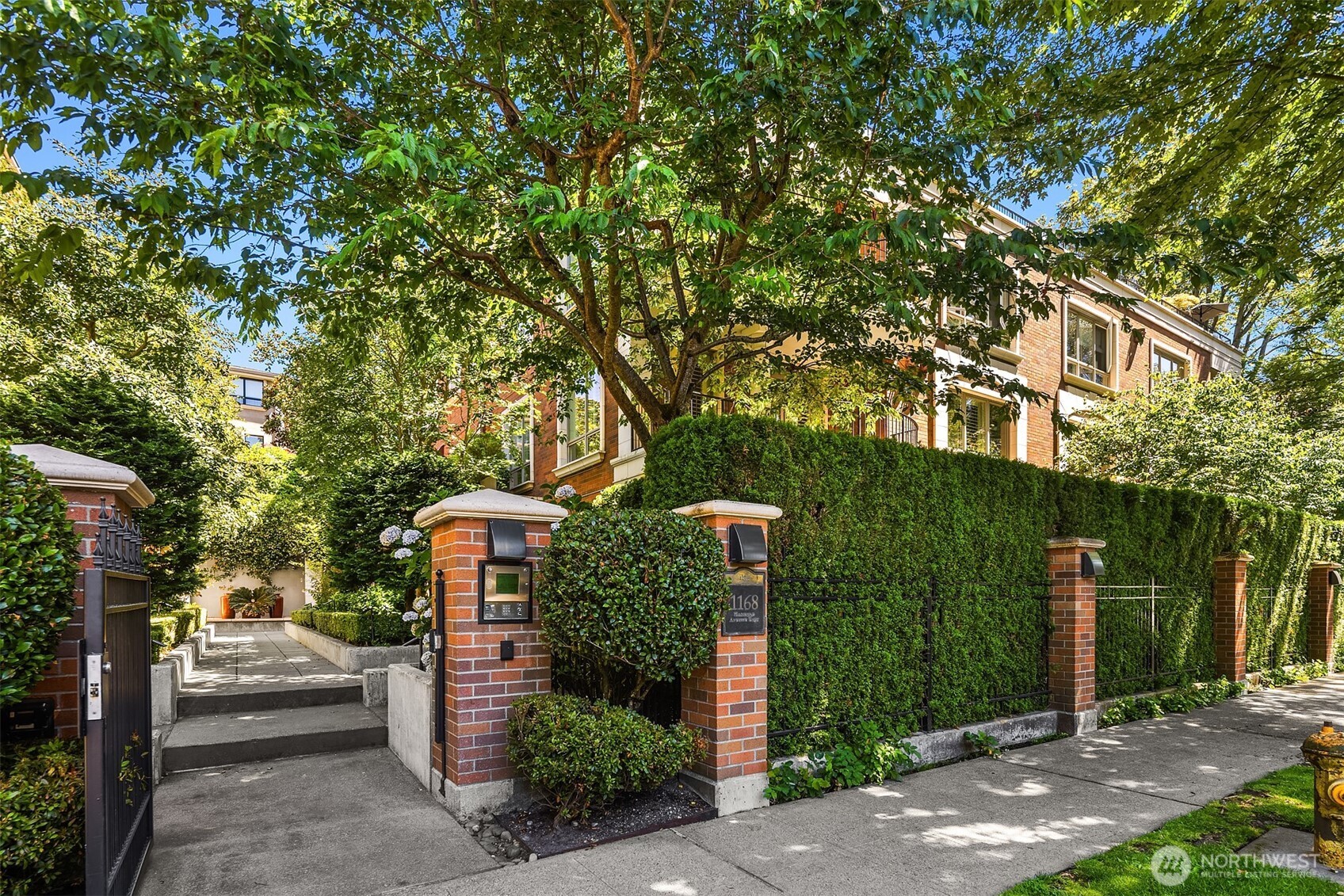 1168 Harvard Avenue East, Unit P7 Seattle, WA 98102 - Photo 1 of 24 a front view of a house with a yard and tree s
