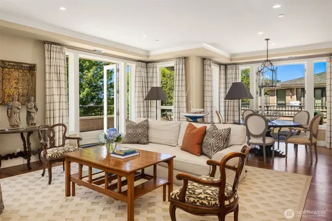 a living room with furniture a table and a large window