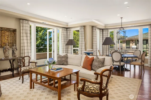 a living room with furniture a table and a large window