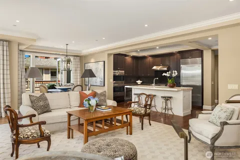 a living room with furniture and a dining table with kitchen view