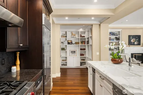 a kitchen with granite countertop a stove and a wooden cabinets