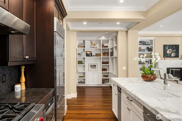 a kitchen with granite countertop a stove and a wooden cabinets