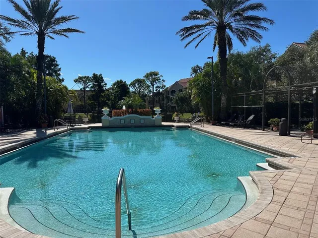 a swimming pool with trees in the background