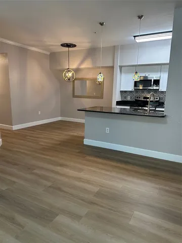 a view of a room with wooden floor and windows