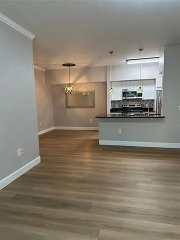 a view of a kitchen with a sink cabinets and a stove top oven