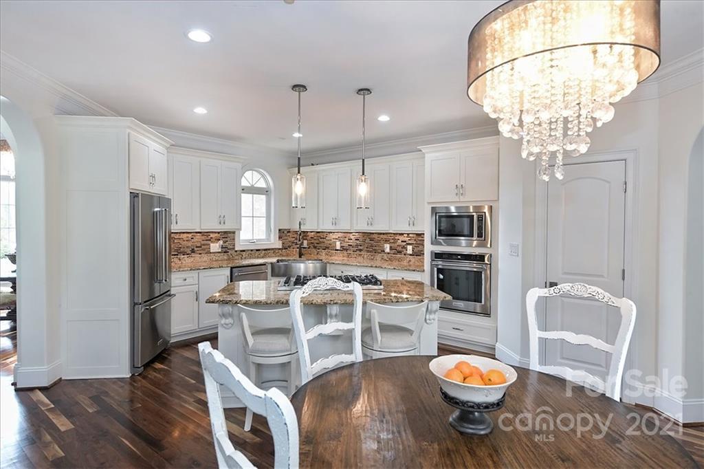 3425 Millstone Creek Road Lancaster, SC 29720 - Photo 14 of 48 a kitchen with stainless steel appliances a dining table and chairs