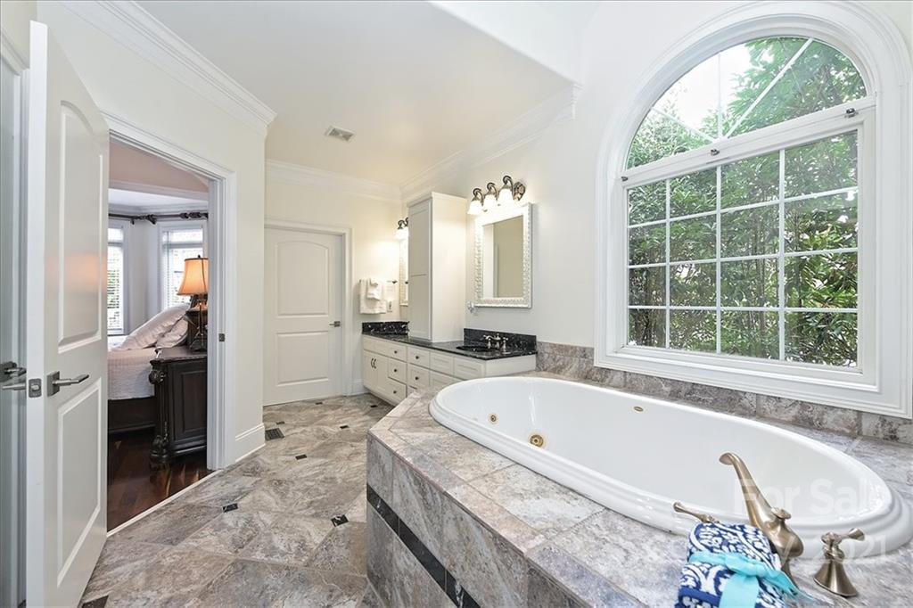 3425 Millstone Creek Road Lancaster, SC 29720 - Photo 22 of 48 a bathroom with a tub a sink and a large window