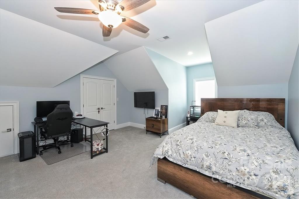 3425 Millstone Creek Road Lancaster, SC 29720 - Photo 36 of 48 a bedroom with a bed furniture and a chandelier