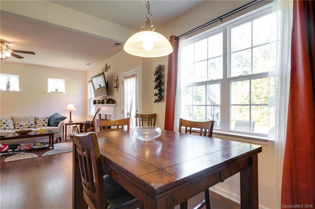 78126 Rillstone Drive, Unit 209 Lancaster, SC 29720 - Photo 11 of 24 a view of a dining room with furniture and wooden floor