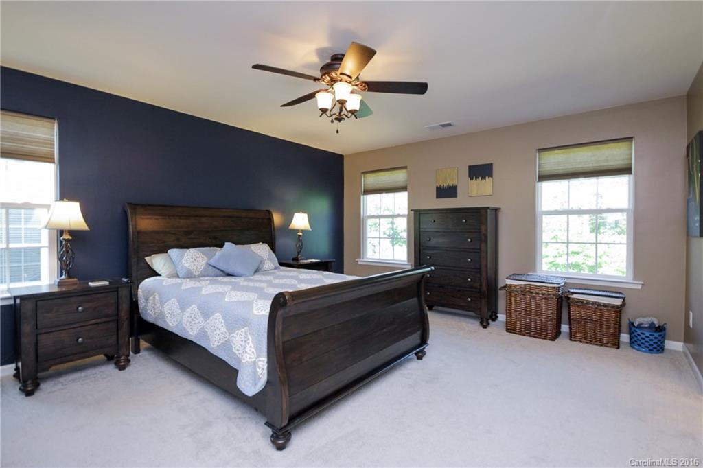 78126 Rillstone Drive, Unit 209 Lancaster, SC 29720 - Photo 12 of 24 a spacious bedroom with a bed and a chandelier