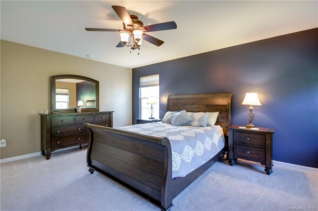 78126 Rillstone Drive, Unit 209 Lancaster, SC 29720 - Photo 13 of 24 a bedroom with a bed and a chandelier