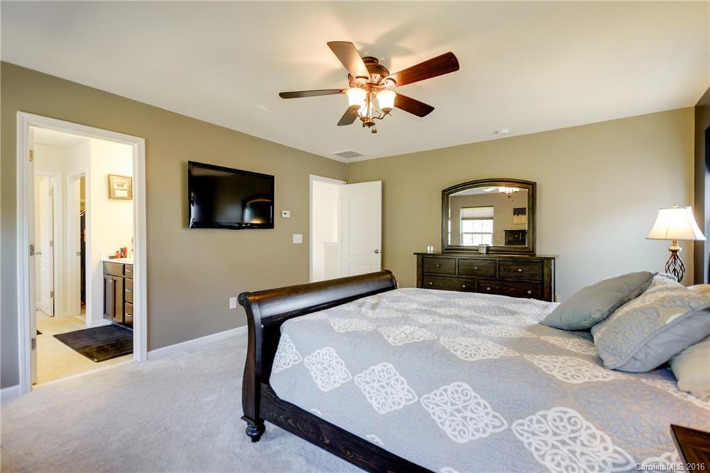 78126 Rillstone Drive, Unit 209 Lancaster, SC 29720 - Photo 14 of 24 a bedroom with a bed and a flat screen tv