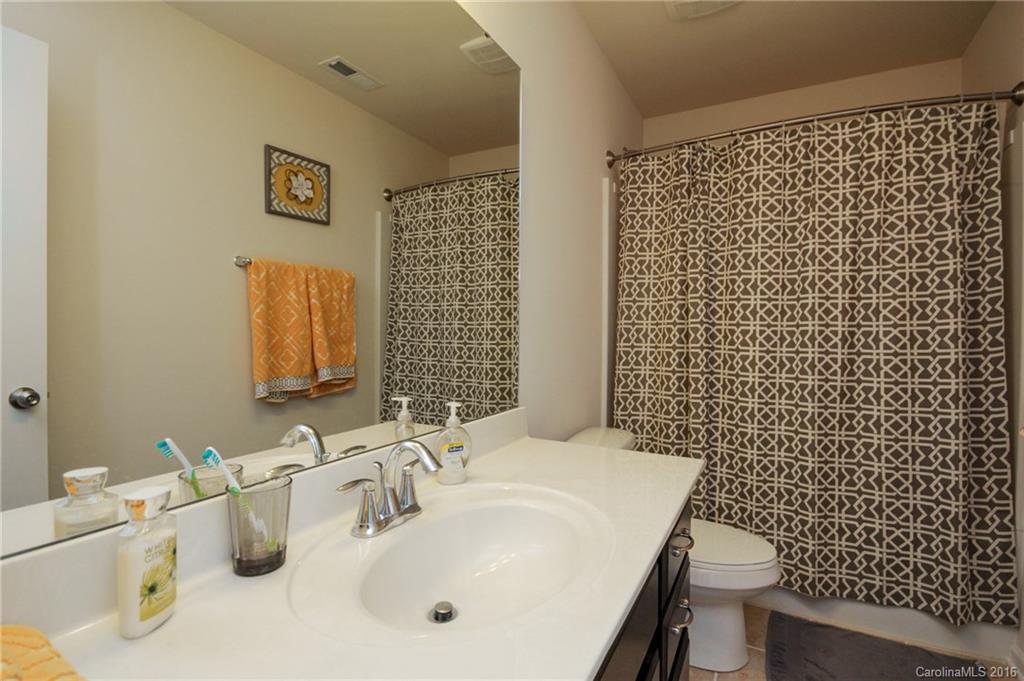 78126 Rillstone Drive, Unit 209 Lancaster, SC 29720 - Photo 19 of 24 a bathroom with a sink a toilet and mirror