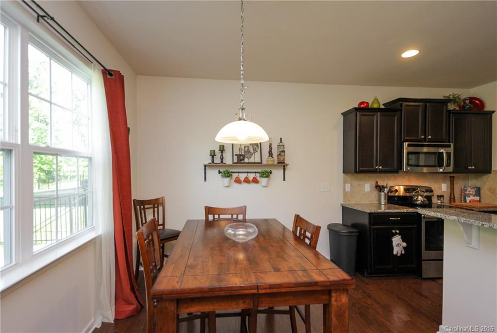 78126 Rillstone Drive, Unit 209 Lancaster, SC 29720 - Photo 3 of 24 a view of a dining room with furniture window and wooden floor