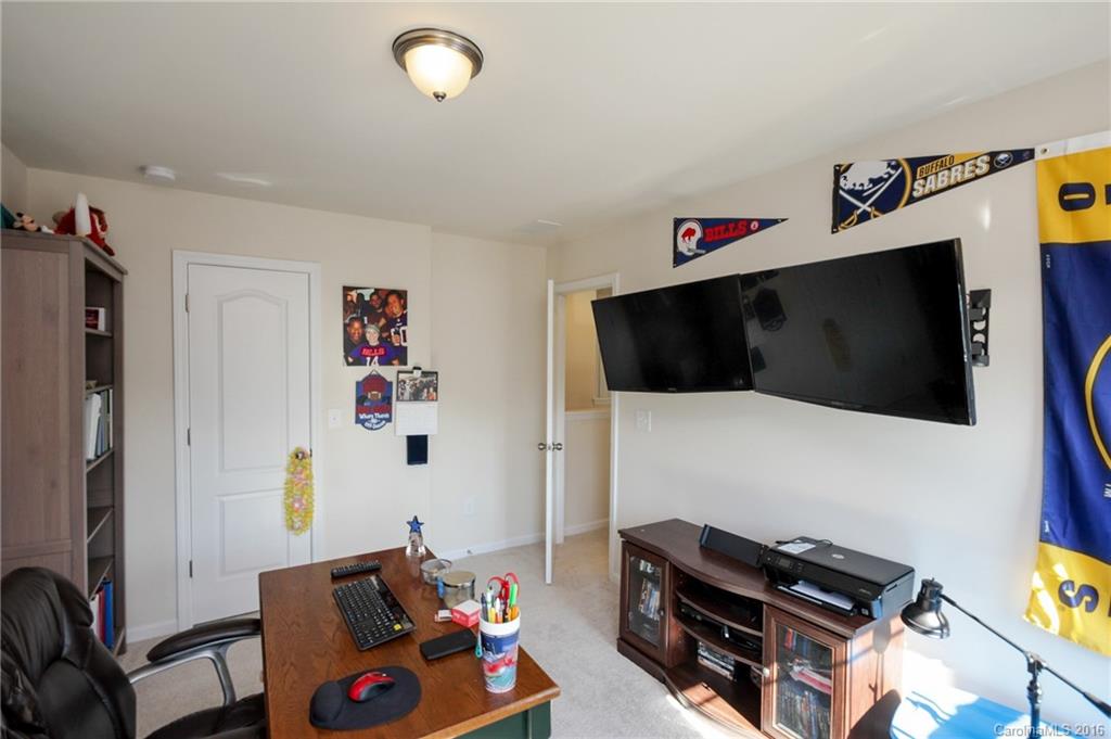 78126 Rillstone Drive, Unit 209 Lancaster, SC 29720 - Photo 21 of 24 a living room with furniture and a flat screen tv