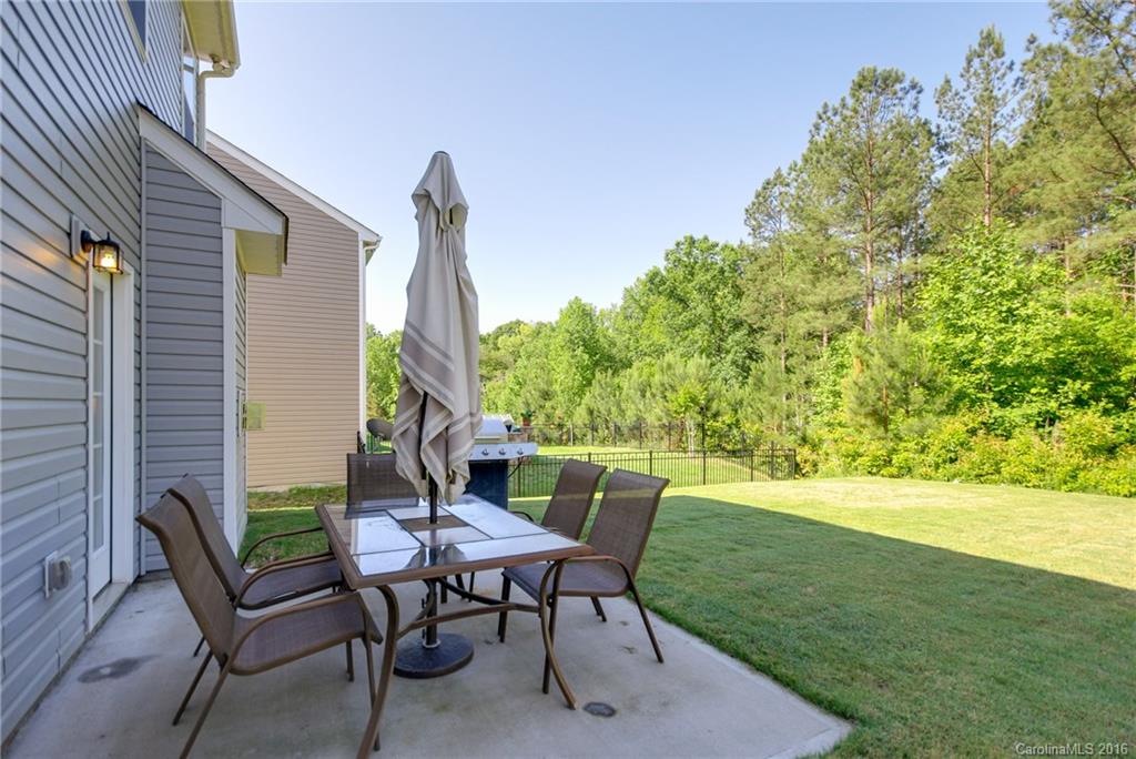 78126 Rillstone Drive, Unit 209 Lancaster, SC 29720 - Photo 24 of 24 a view of a chairs and table in backyard of the house