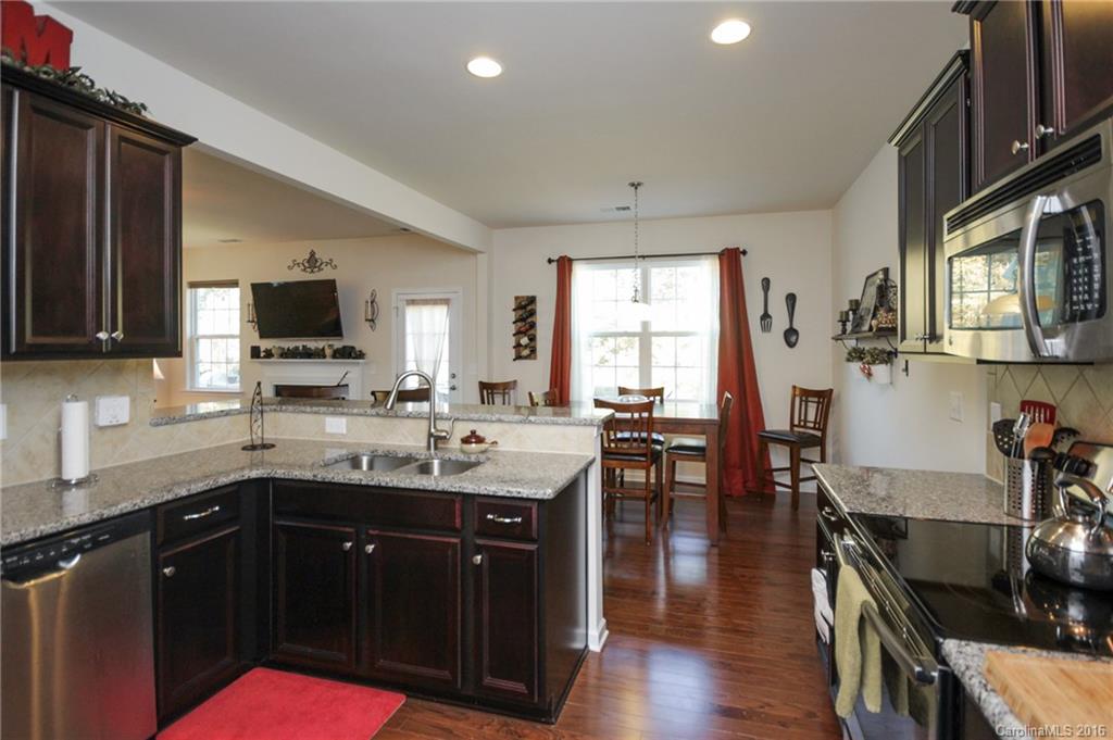 78126 Rillstone Drive, Unit 209 Lancaster, SC 29720 - Photo 7 of 24 a kitchen with granite countertop a sink appliances and cabinets
