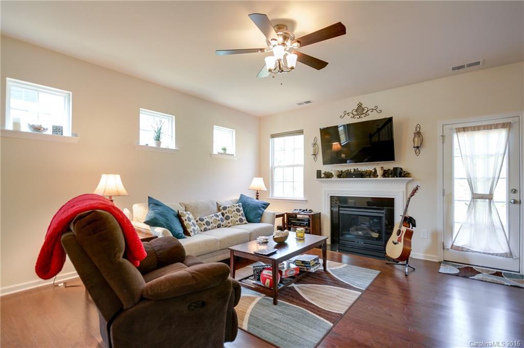 78126 Rillstone Drive, Unit 209 Lancaster, SC 29720 - Photo 8 of 24 a living room with furniture a fireplace and a flat screen tv