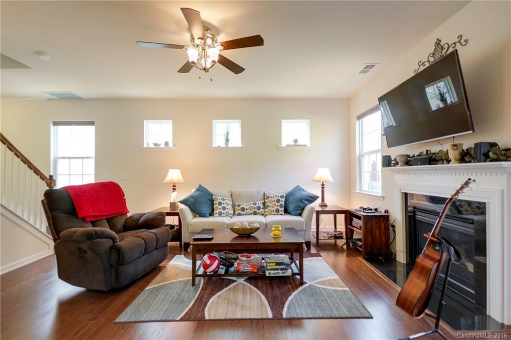 78126 Rillstone Drive, Unit 209 Lancaster, SC 29720 - Photo 9 of 24 a living room with furniture flat screen tv and a fireplace