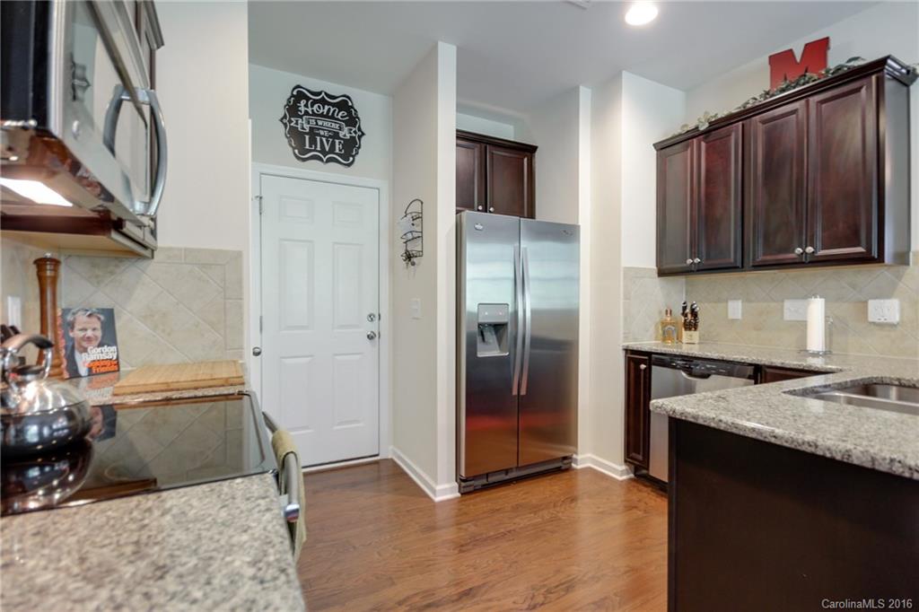 78126 Rillstone Drive, Unit 209 Lancaster, SC 29720 - Photo 10 of 24 a kitchen with granite countertop a refrigerator and a sink