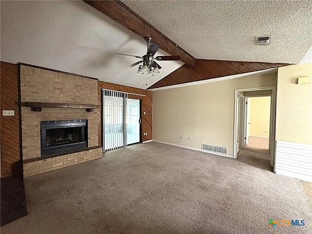 a view of empty room with fireplace