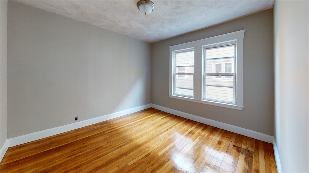 5 Edgar Terrace, Unit 2 Somerville, MA 02145 - Photo 4 of 6 a view of an empty room and window