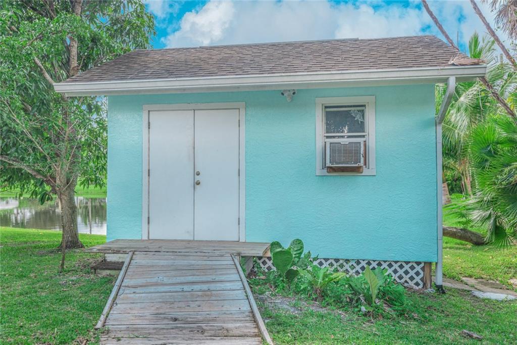 1128 Northwest Fork Road Stuart, FL 34994 - Photo 19 of 23 a front view of a house with a garden
