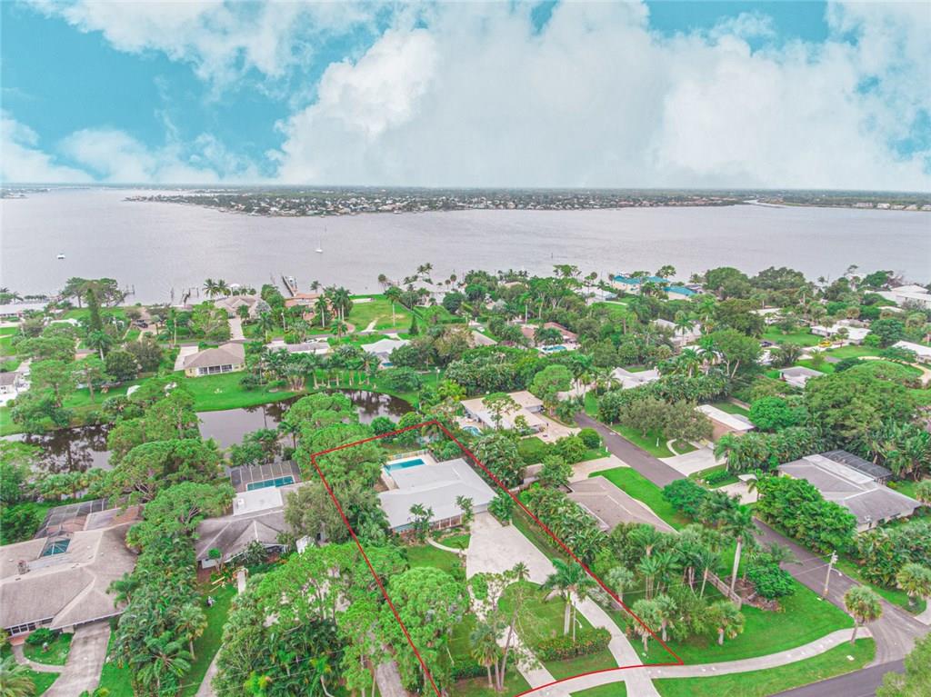 1128 Northwest Fork Road Stuart, FL 34994 - Photo 20 of 23 an aerial view of a house with a garden and lake view