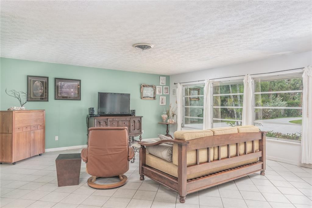 1128 Northwest Fork Road Stuart, FL 34994 - Photo 3 of 23 a bedroom with furniture and a window