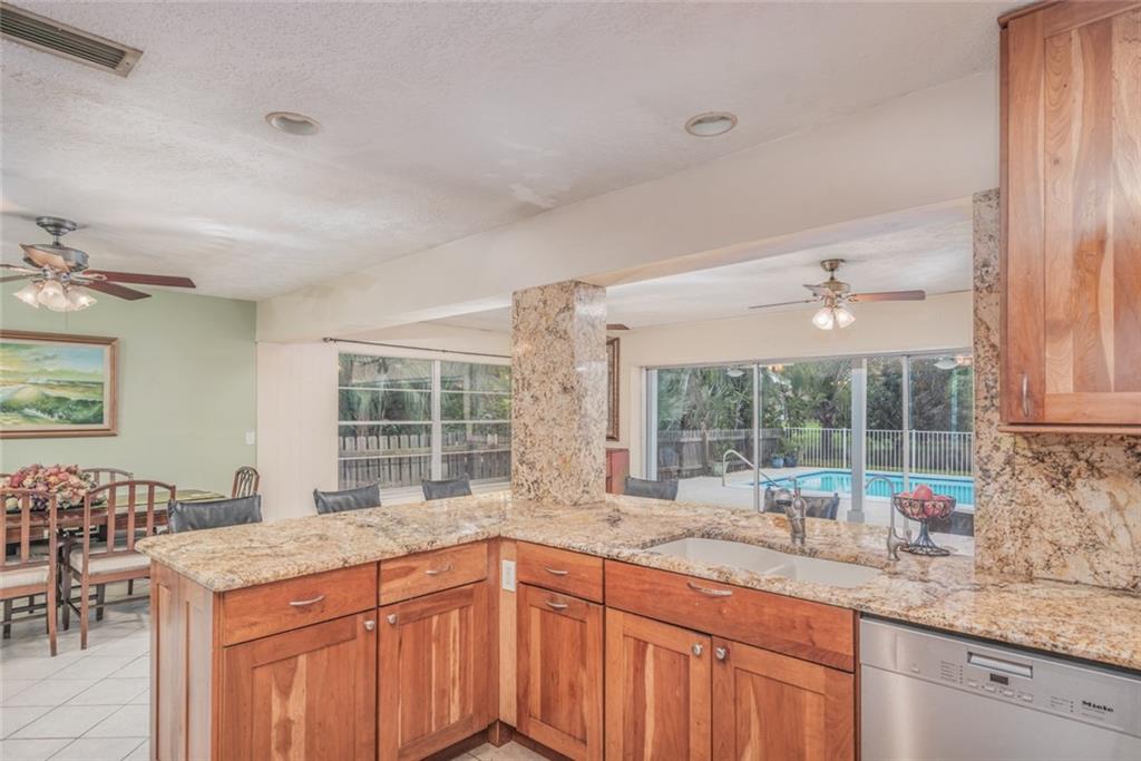1128 Northwest Fork Road Stuart, FL 34994 - Photo 8 of 23 a kitchen with granite countertop a sink and a stove