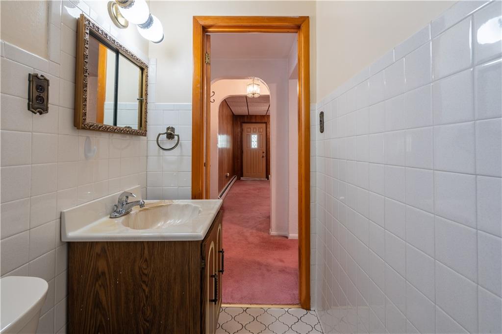 2509 Spring Street Pittsburgh, PA 15210 - Photo 16 of 31 a en suite bathroom with a sink and a mirror
