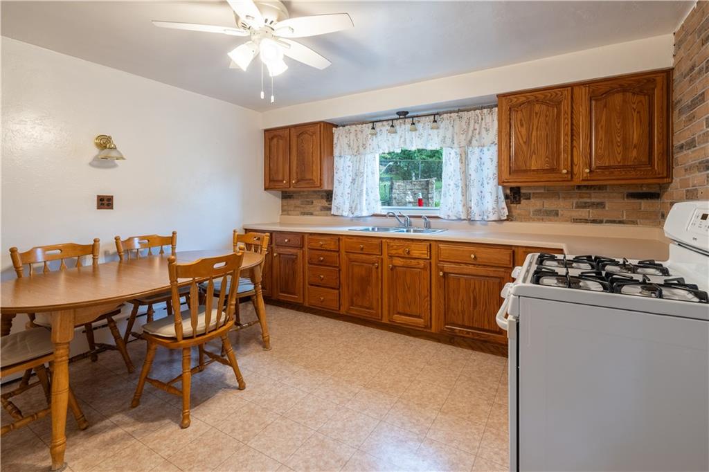 2509 Spring Street Pittsburgh, PA 15210 - Photo 2 of 31 a kitchen with a dining table and chairs