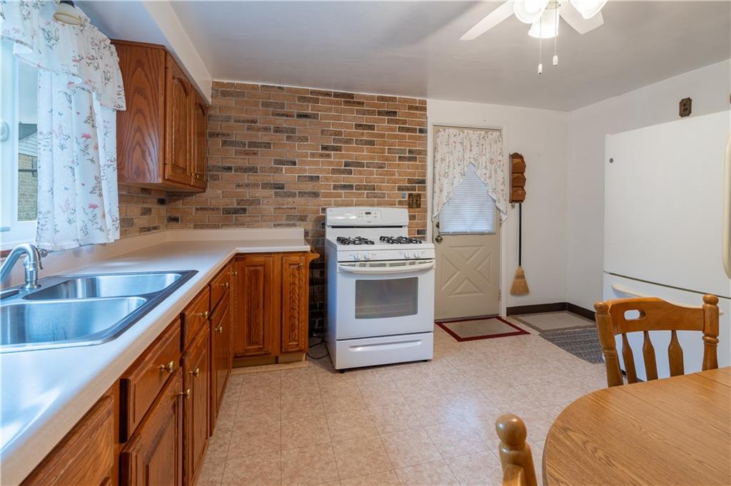 2509 Spring Street Pittsburgh, PA 15210 - Photo 5 of 31 a kitchen with stainless steel appliances granite countertop a stove a sink and a refrigerator