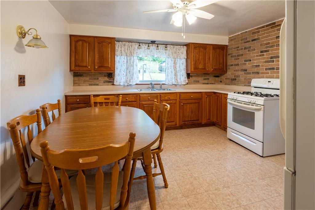 2509 Spring Street Pittsburgh, PA 15210 - Photo 6 of 31 a kitchen with a table chairs sink and cabinets