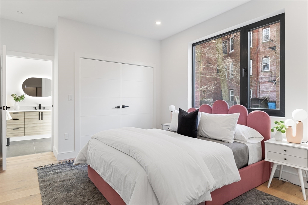 41 University Road, Unit 3 Brookline, MA 02445 - Photo 16 of 21 a bedroom with a bed a large window and walk in closet