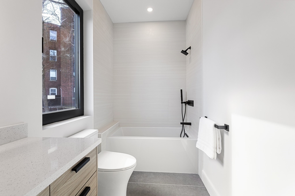 41 University Road, Unit 3 Brookline, MA 02445 - Photo 17 of 21 a bathroom with a sink a toilet and shower