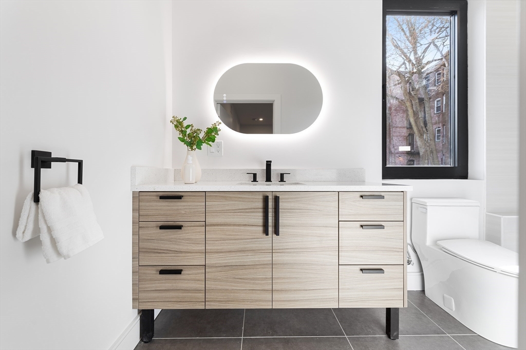 41 University Road, Unit 3 Brookline, MA 02445 - Photo 18 of 21 a bathroom with a sink and a mirror
