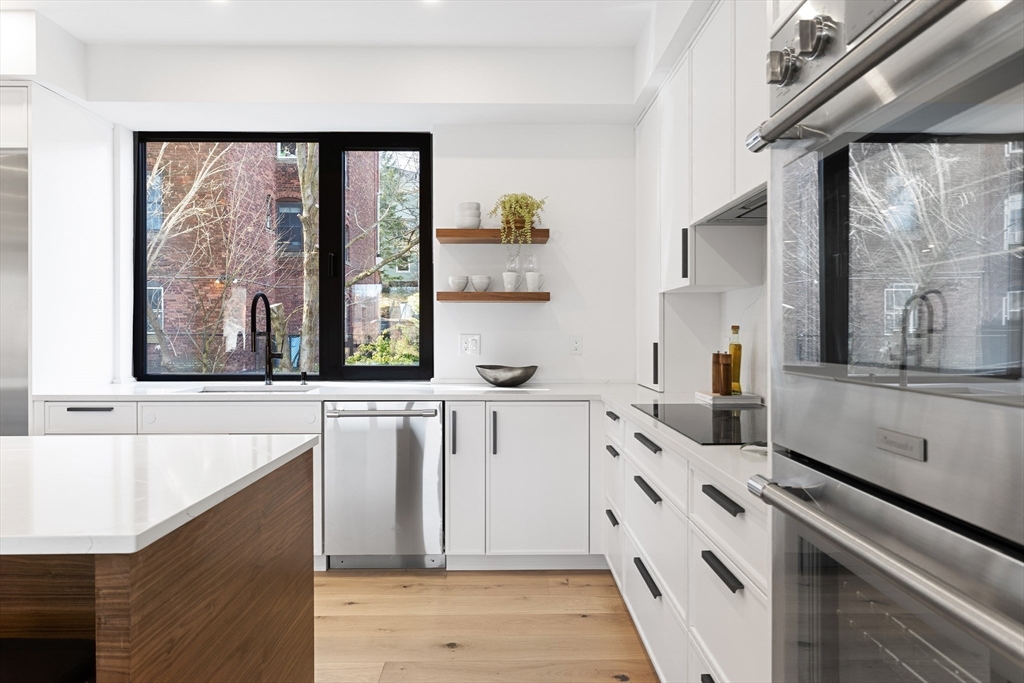 41 University Road, Unit 3 Brookline, MA 02445 - Photo 2 of 21 a kitchen with a stove a sink and a refrigerator