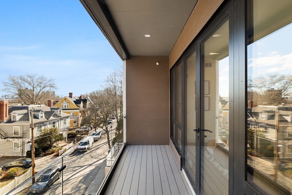 41 University Road, Unit 3 Brookline, MA 02445 - Photo 21 of 21 a view of a balcony with wooden floor