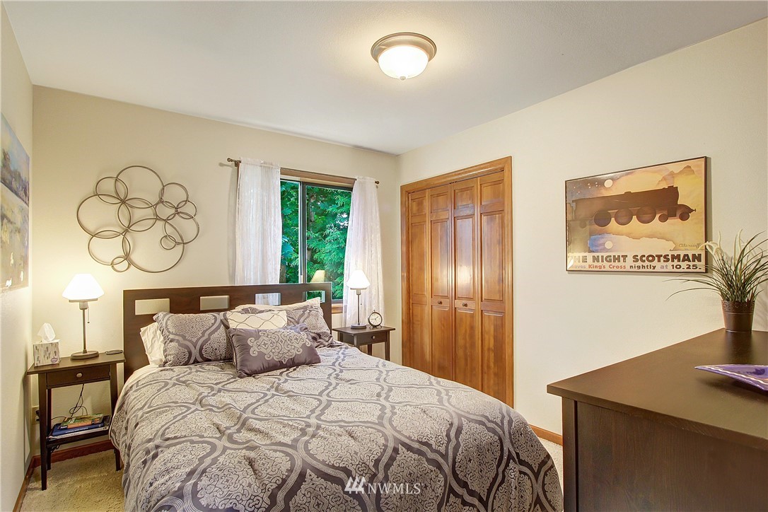 21720 42 Avenue Southeast Bothell, WA 98021 - Photo 22 of 30 a bedroom with a bed and paintings on the wall